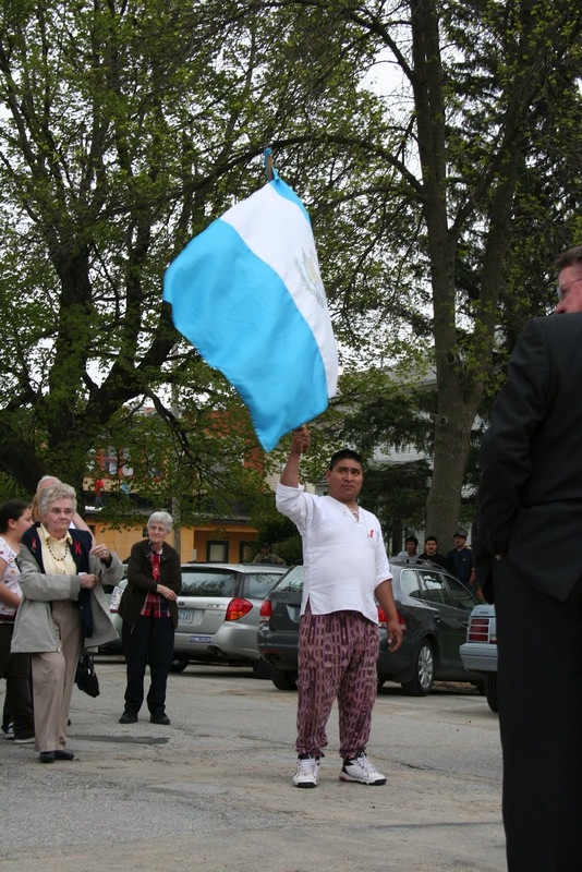 Sister Mary McCauley, marcher with Guatemalan flag.JPG