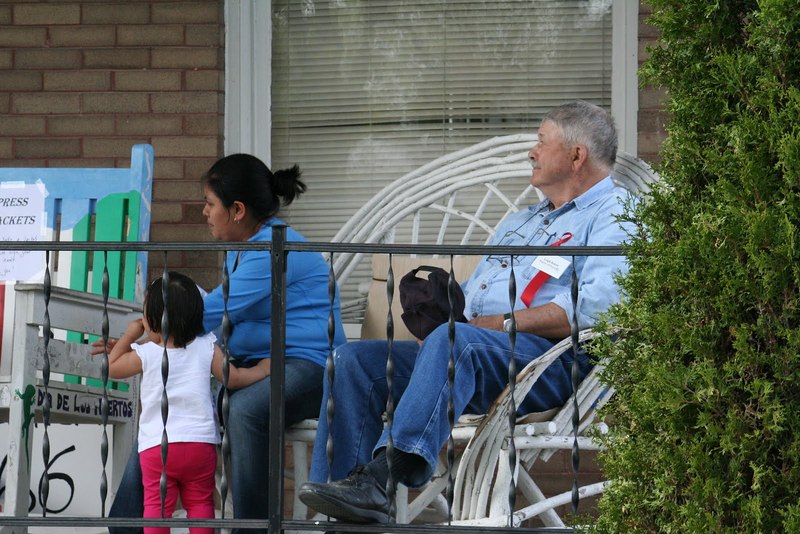 Woman, child, man sitting on porch.JPG
