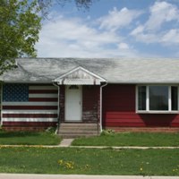 Postville house with American flag